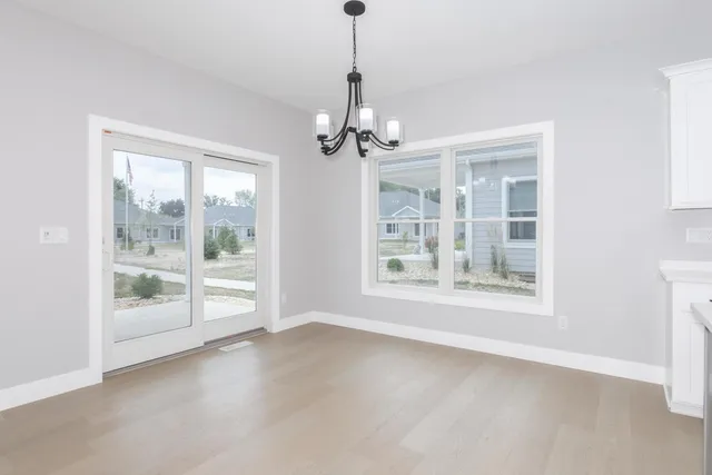 a view of a kitchen with large windows