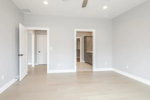 a spacious bathroom with a double vanity sink and mirror