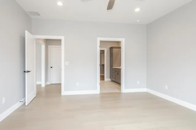 a spacious bathroom with a double vanity sink and mirror
