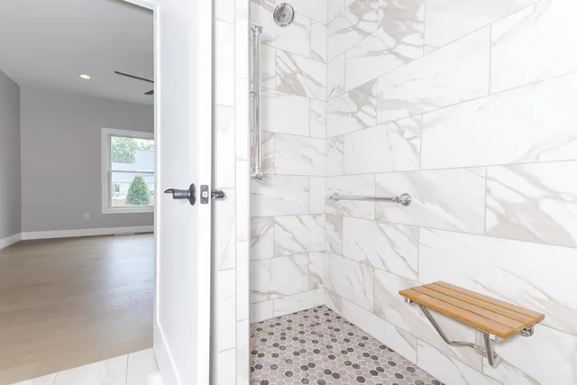 a spacious bathroom with a double vanity sink a large mirror and a shower