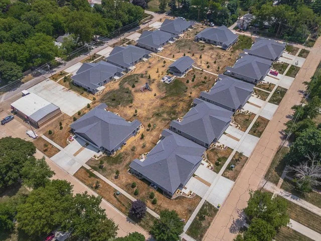 an aerial view of residential houses and car parked