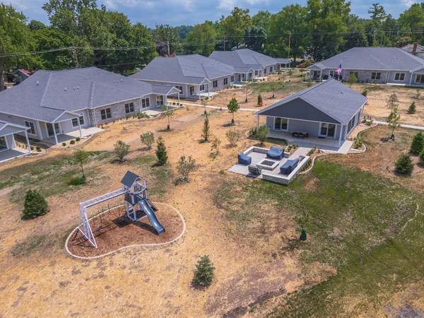 a view of a house with swimming pool and sitting area