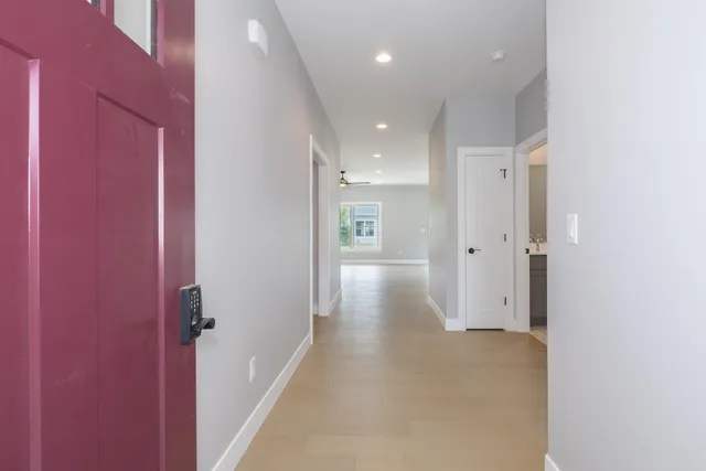 a view of a hallway with wooden shelves