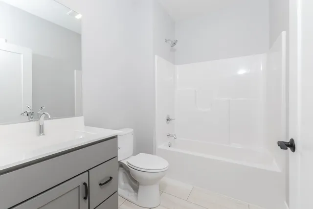 a view of a hallway with wooden floor and closet area