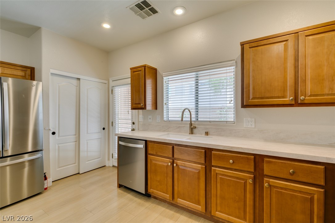 8909 Houston Ridge Avenue Las Vegas, NV 89178 - Photo 19 of 45 A well-appointed kitchen showcasing contemporary appliances and warm cabinetry.