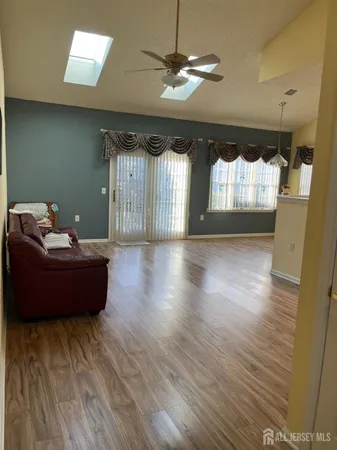 a living room with couch and a wooden floor
