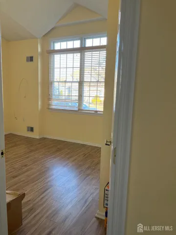 a view of walk in closet with empty racks