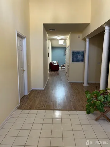 a view of an empty room with wooden floor