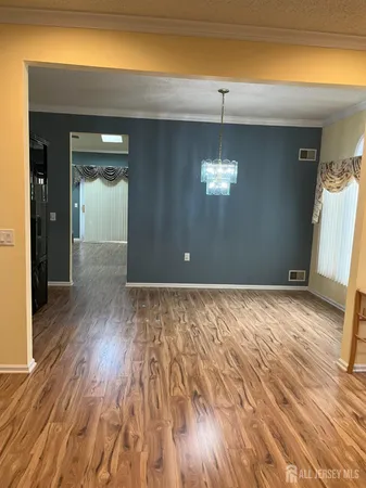 a kitchen with wooden floors and a refrigerator