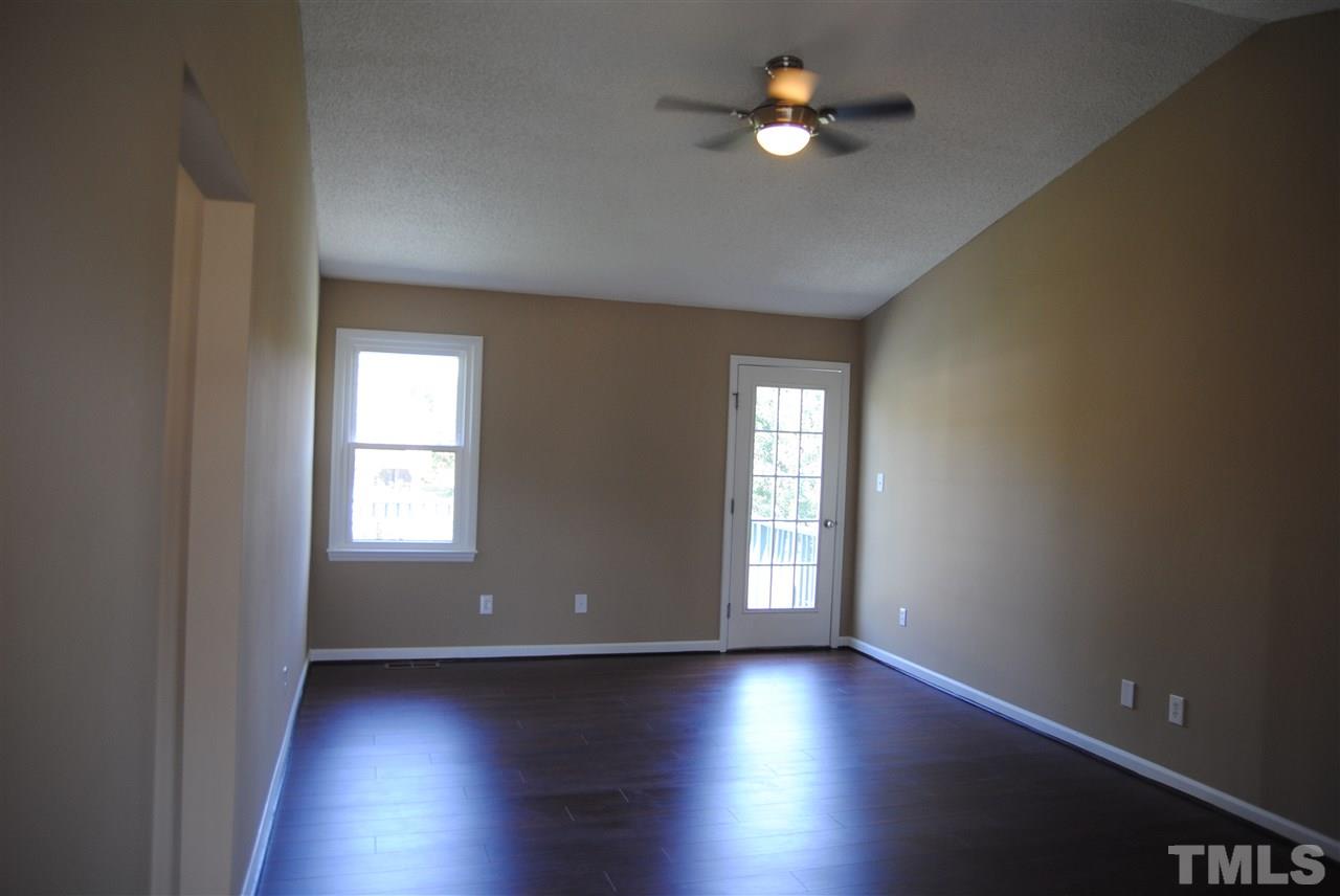 1821 Billingham Court Raleigh, NC 27604 - Photo 2 of 14 wooden floor in an empty room with a window