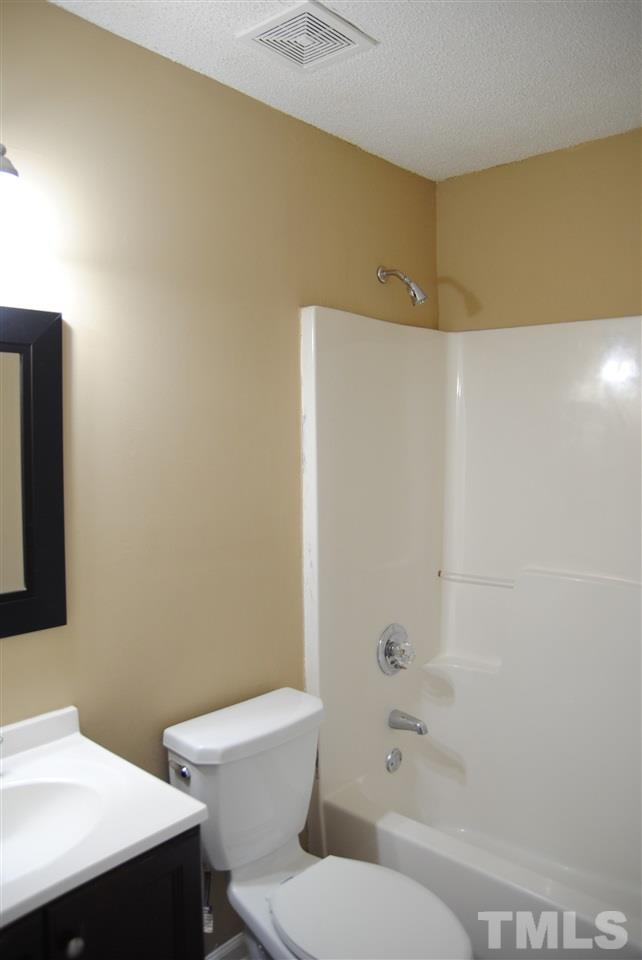 1821 Billingham Court Raleigh, NC 27604 - Photo 11 of 14 a bathroom with a toilet a sink and shower