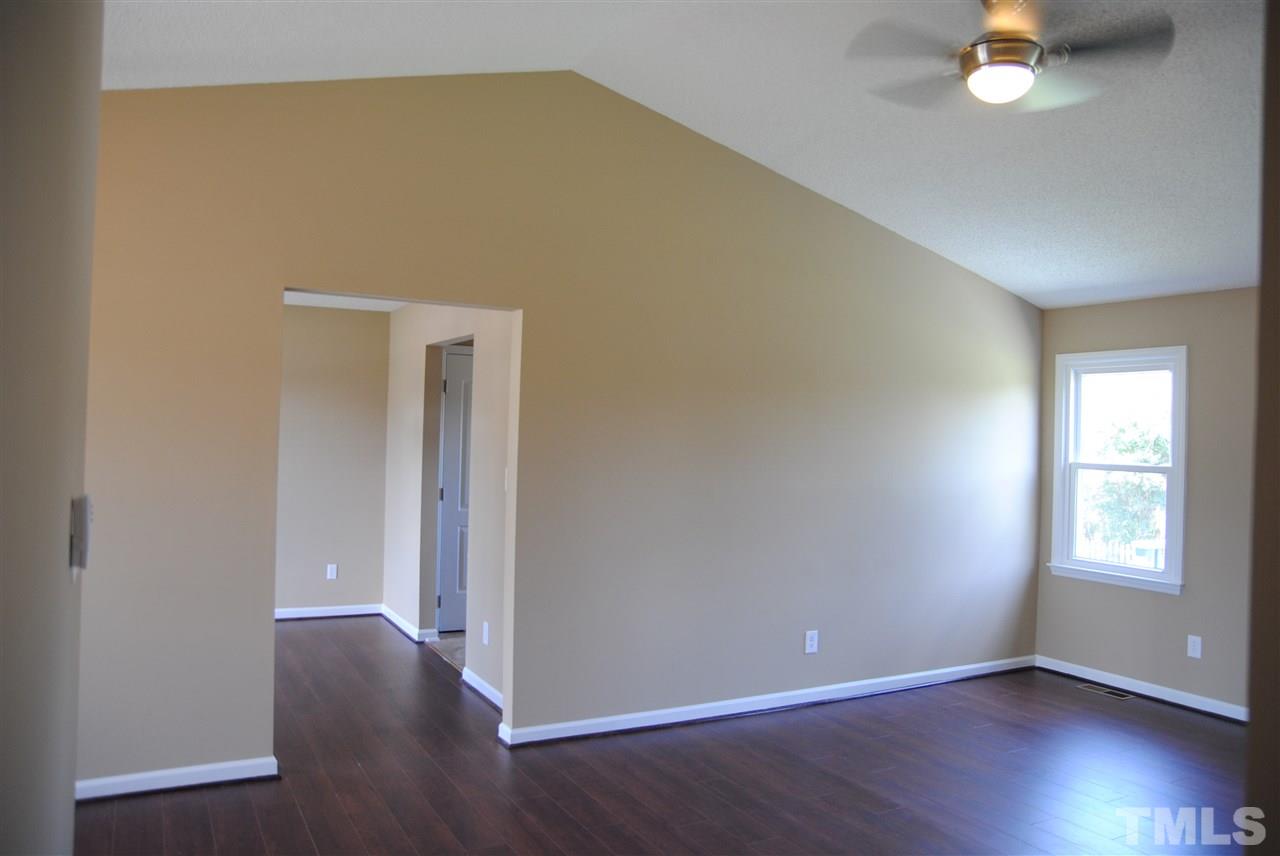 1821 Billingham Court Raleigh, NC 27604 - Photo 4 of 14 a view of an empty room with wooden floor and a window