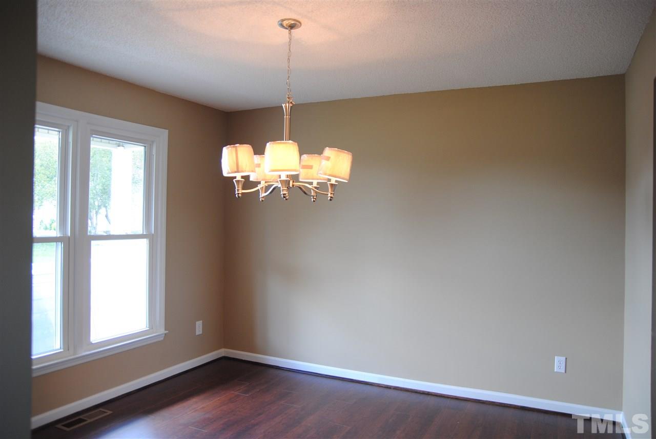 1821 Billingham Court Raleigh, NC 27604 - Photo 5 of 14 a view of a room with a chandelier fan and windows