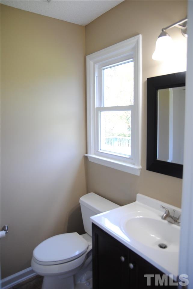 1821 Billingham Court Raleigh, NC 27604 - Photo 9 of 14 a bathroom with a sink a toilet and a window