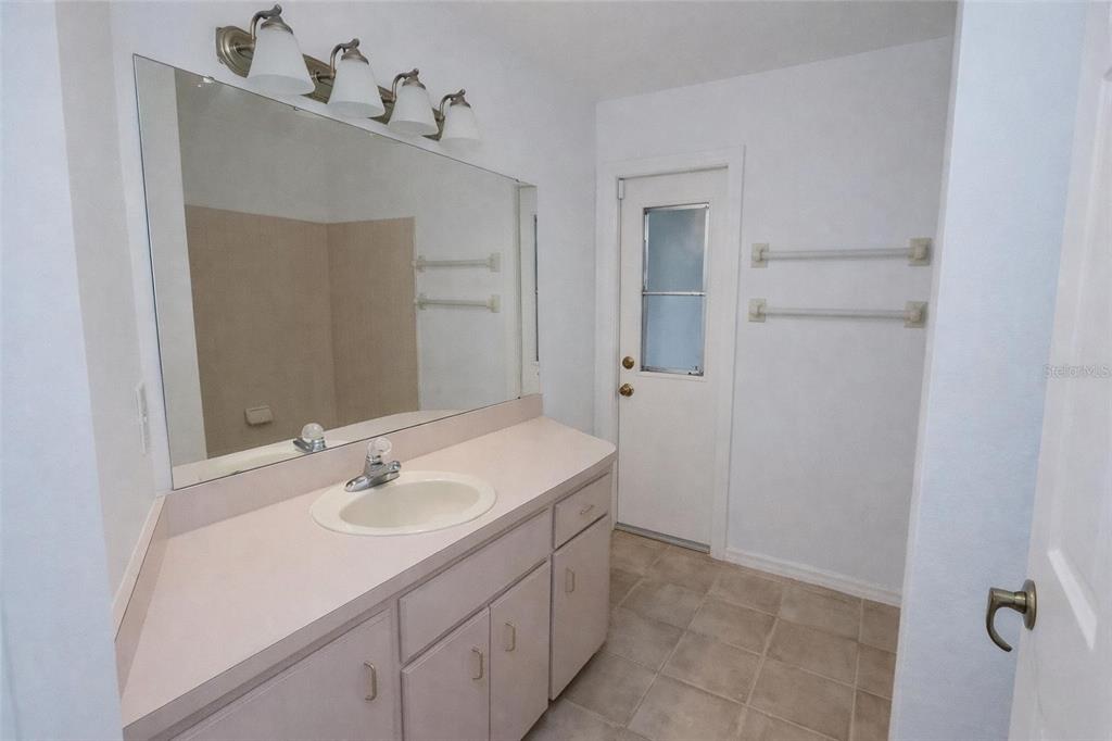 8276 Short Way Lakeland, FL 33809 - Photo 4 of 12 a bathroom with a sink and a mirror
