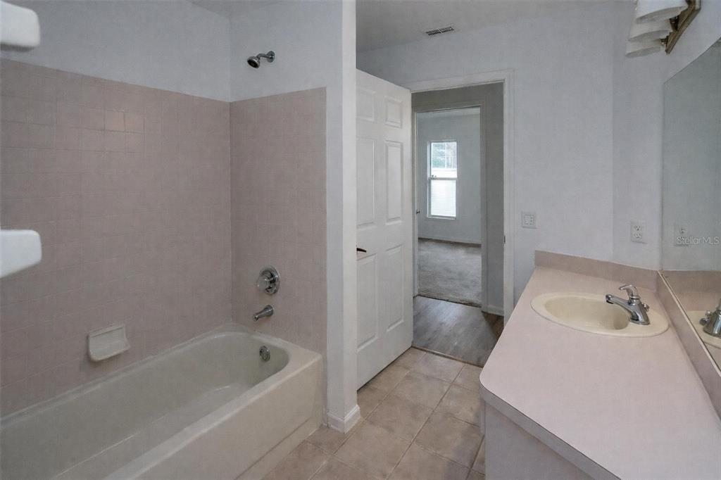 8276 Short Way Lakeland, FL 33809 - Photo 5 of 12 a bathroom with a bathtub sink and toilet