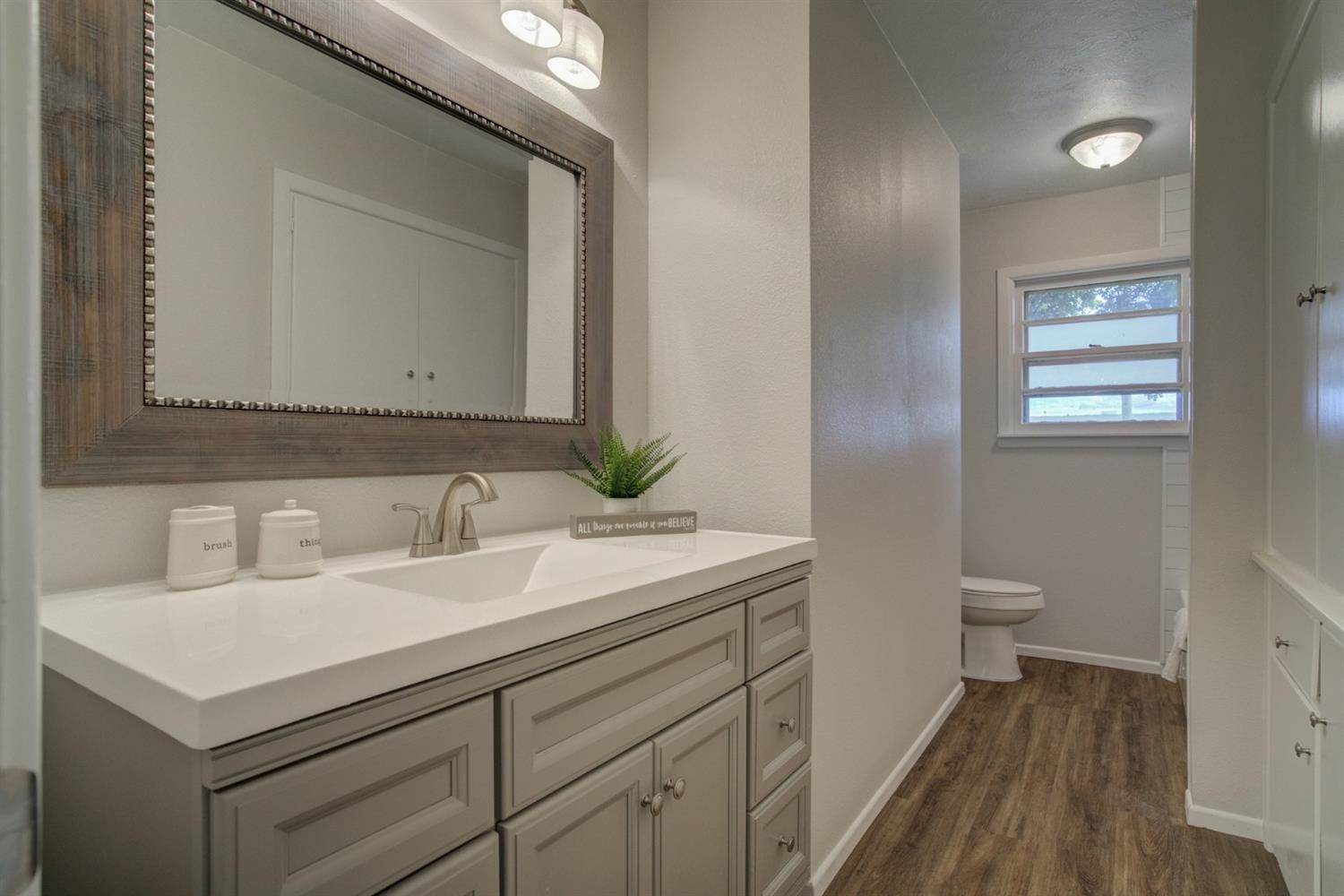 2311 61st Street Lubbock, TX 79412 - Photo 23 of 32 a bathroom with a sink and a mirror