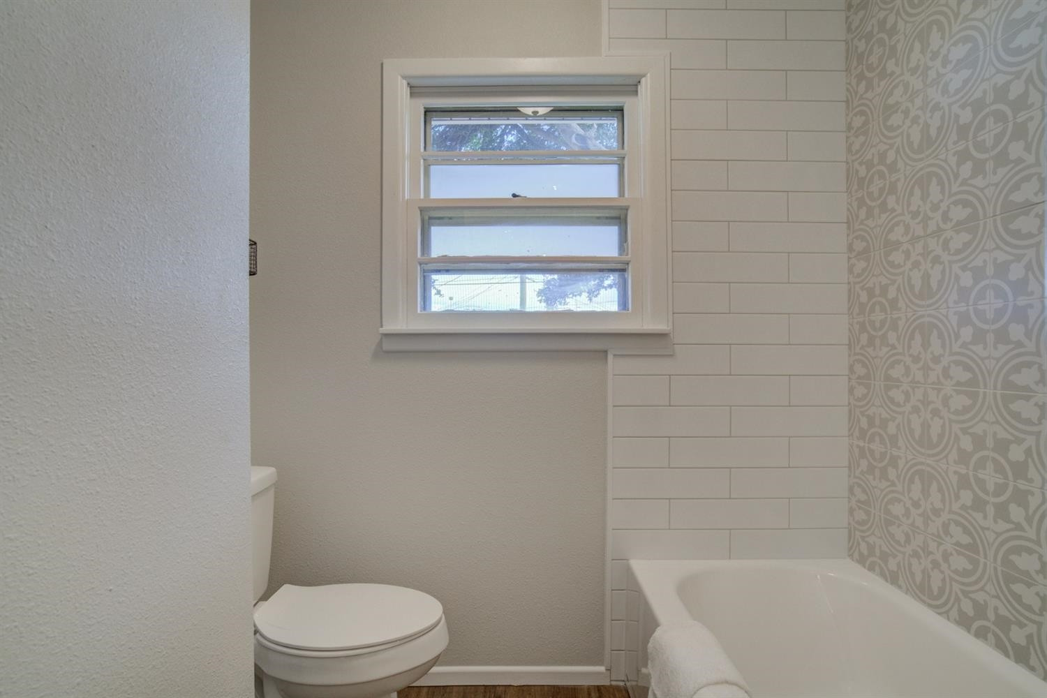 2311 61st Street Lubbock, TX 79412 - Photo 24 of 32 a white toilet sitting next to a bath tub