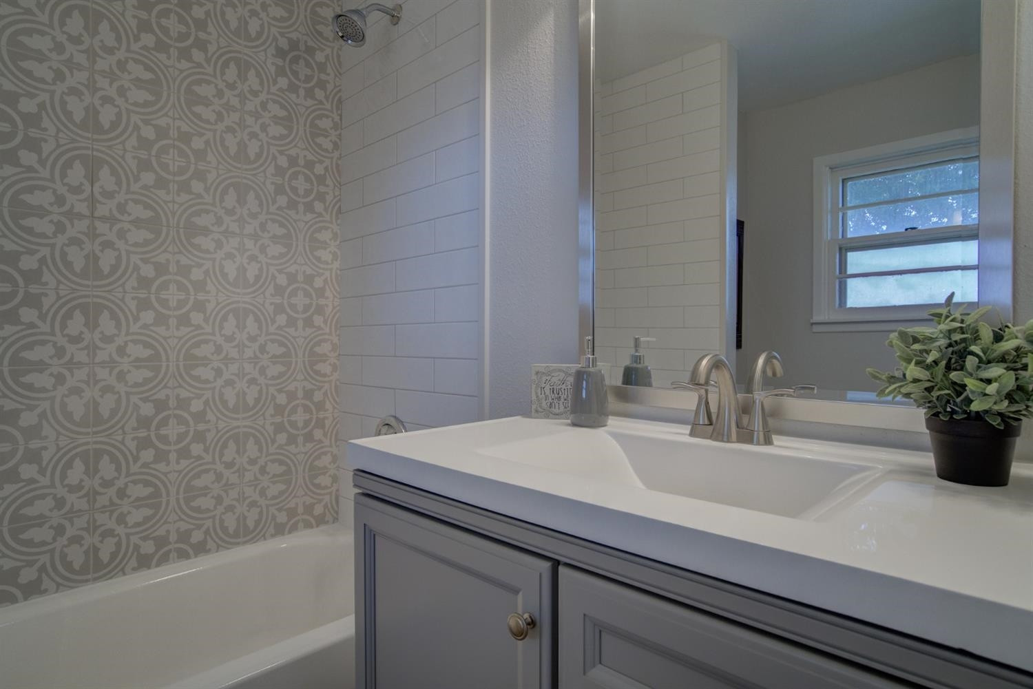 2311 61st Street Lubbock, TX 79412 - Photo 28 of 32 a bathroom with a sink and a bathtub