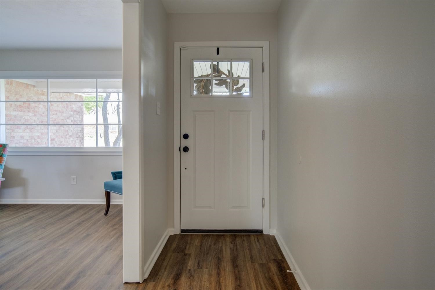 2311 61st Street Lubbock, TX 79412 - Photo 4 of 32 wooden floor in an empty room with a window