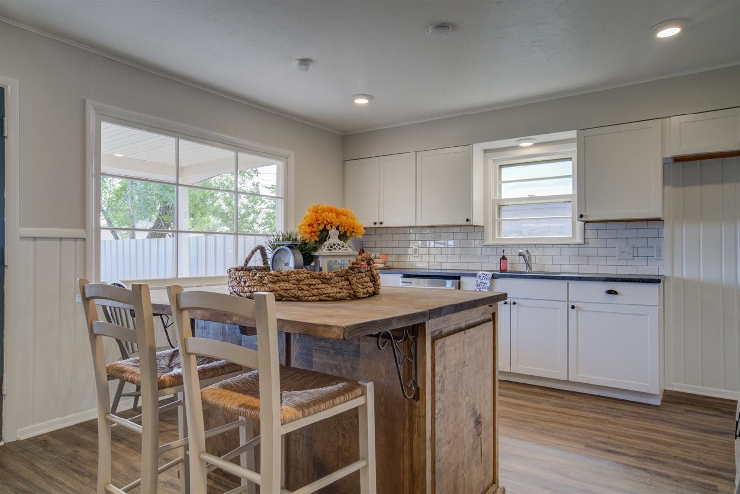 2311 61st Street Lubbock, TX 79412 - Photo 10 of 32 a kitchen with a stove a table and chairs in it