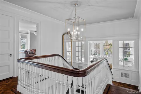 a living room with furniture and floor to ceiling windows