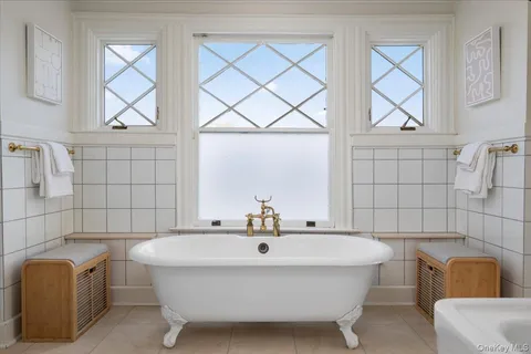 a bathroom with a white toilet a sink and shower