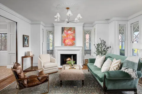 a living room with furniture fireplace and flat screen tv