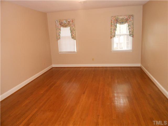 3504 Ranlo Drive Raleigh, NC 27612 - Photo 5 of 10 an empty room with wooden floor and windows