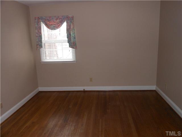 3504 Ranlo Drive Raleigh, NC 27612 - Photo 6 of 10 a view of an empty room with wooden floor and a window