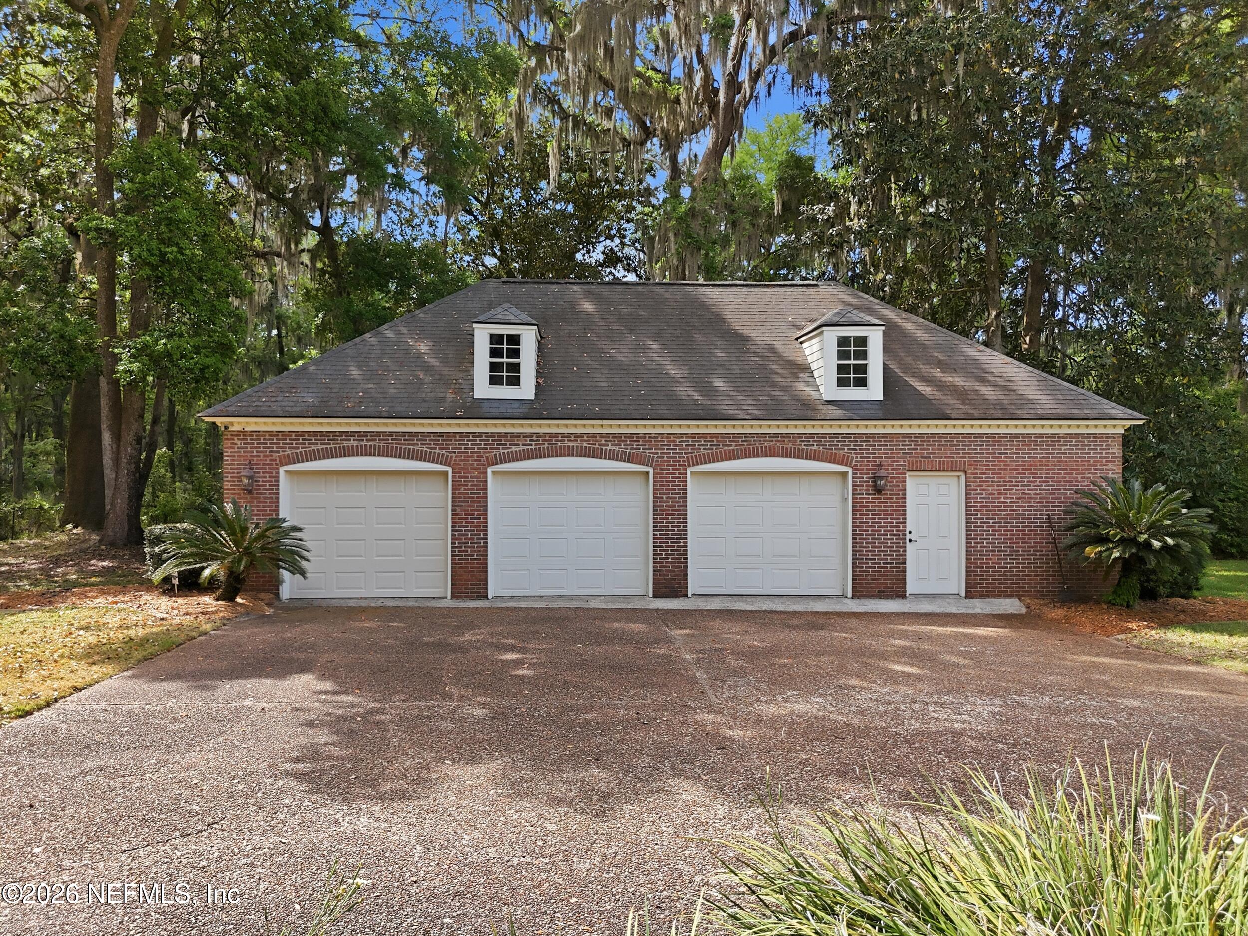 13200 Mandarin Road Jacksonville, FL 32223 - Photo 133 of 173 a front view of a house with a yard and garage