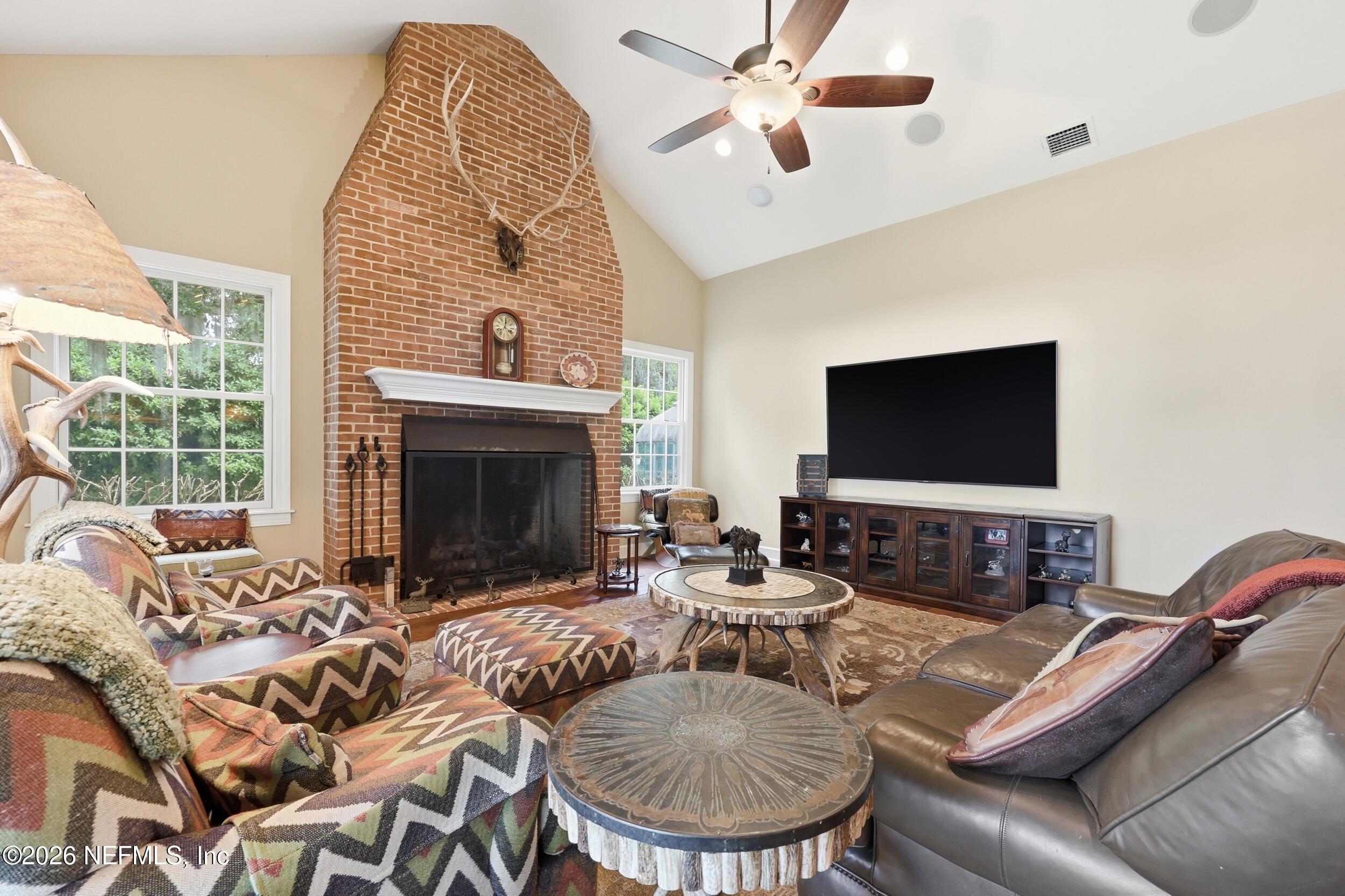 13200 Mandarin Road Jacksonville, FL 32223 - Photo 47 of 173 a living room with furniture a flat screen tv and a fireplace