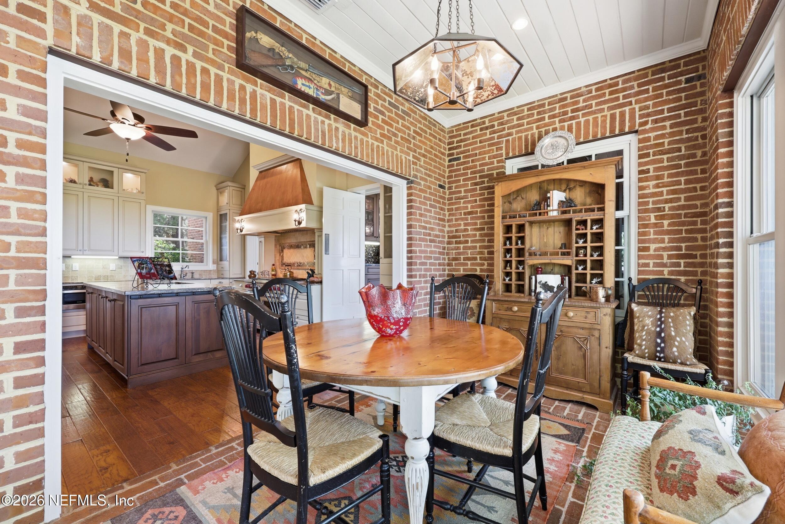 13200 Mandarin Road Jacksonville, FL 32223 - Photo 51 of 173 a dining room with furniture a chandelier and wooden floor