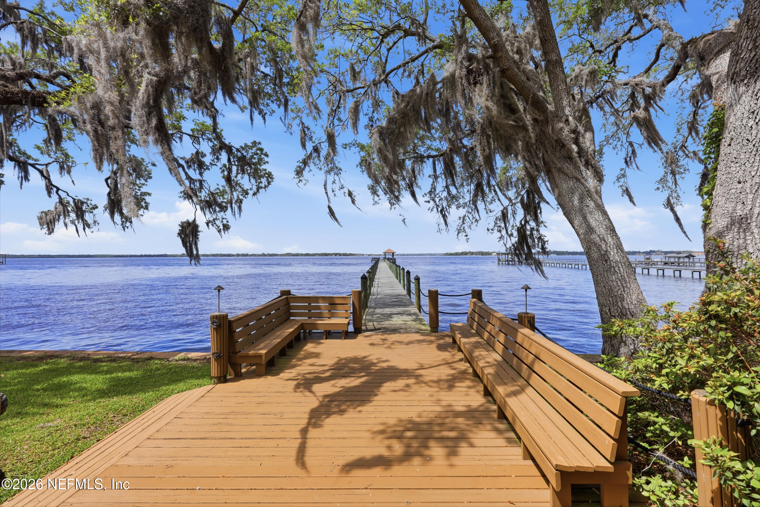 13200 Mandarin Road Jacksonville, FL 32223 - Photo 56 of 173 a roof deck with table and chairs with wooden floor and fence