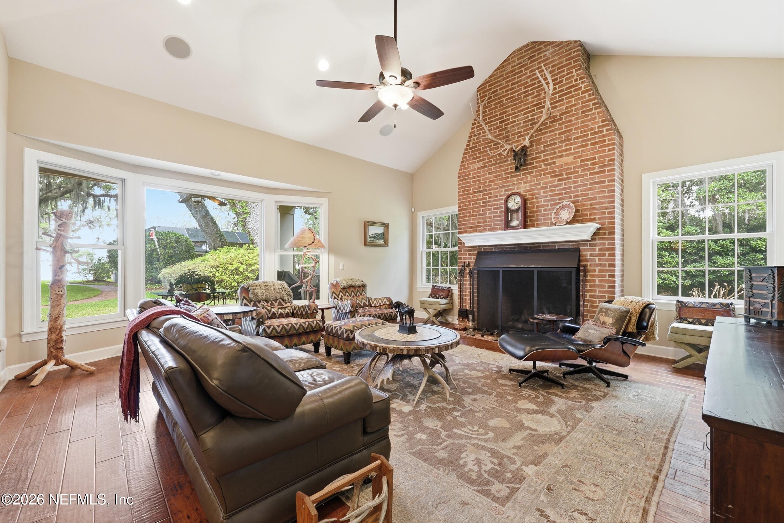 13200 Mandarin Road Jacksonville, FL 32223 - Photo 58 of 173 a living room with furniture a fireplace and a floor to ceiling window