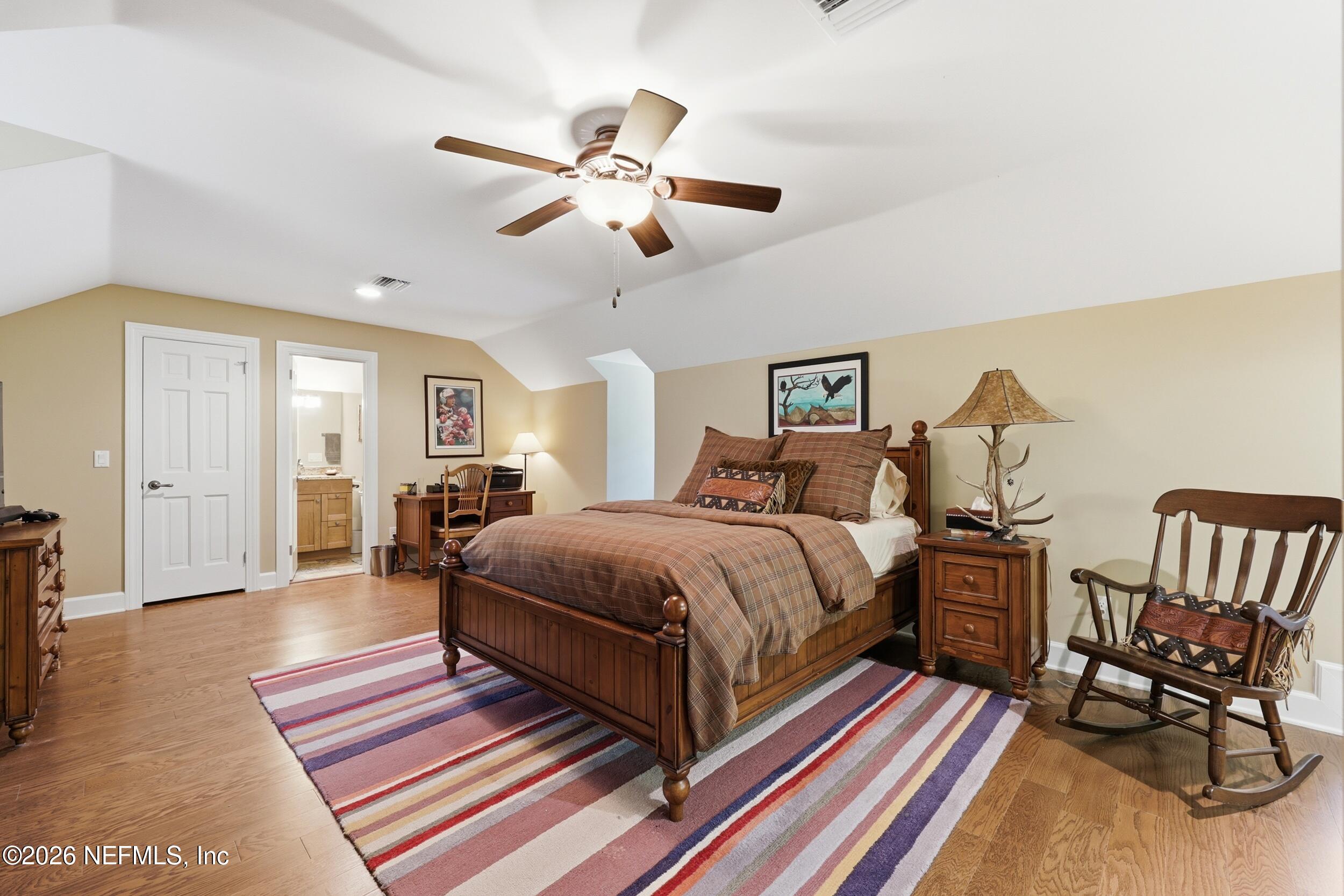 13200 Mandarin Road Jacksonville, FL 32223 - Photo 76 of 173 a spacious bedroom with a bed a chair and potted plant on the dresser