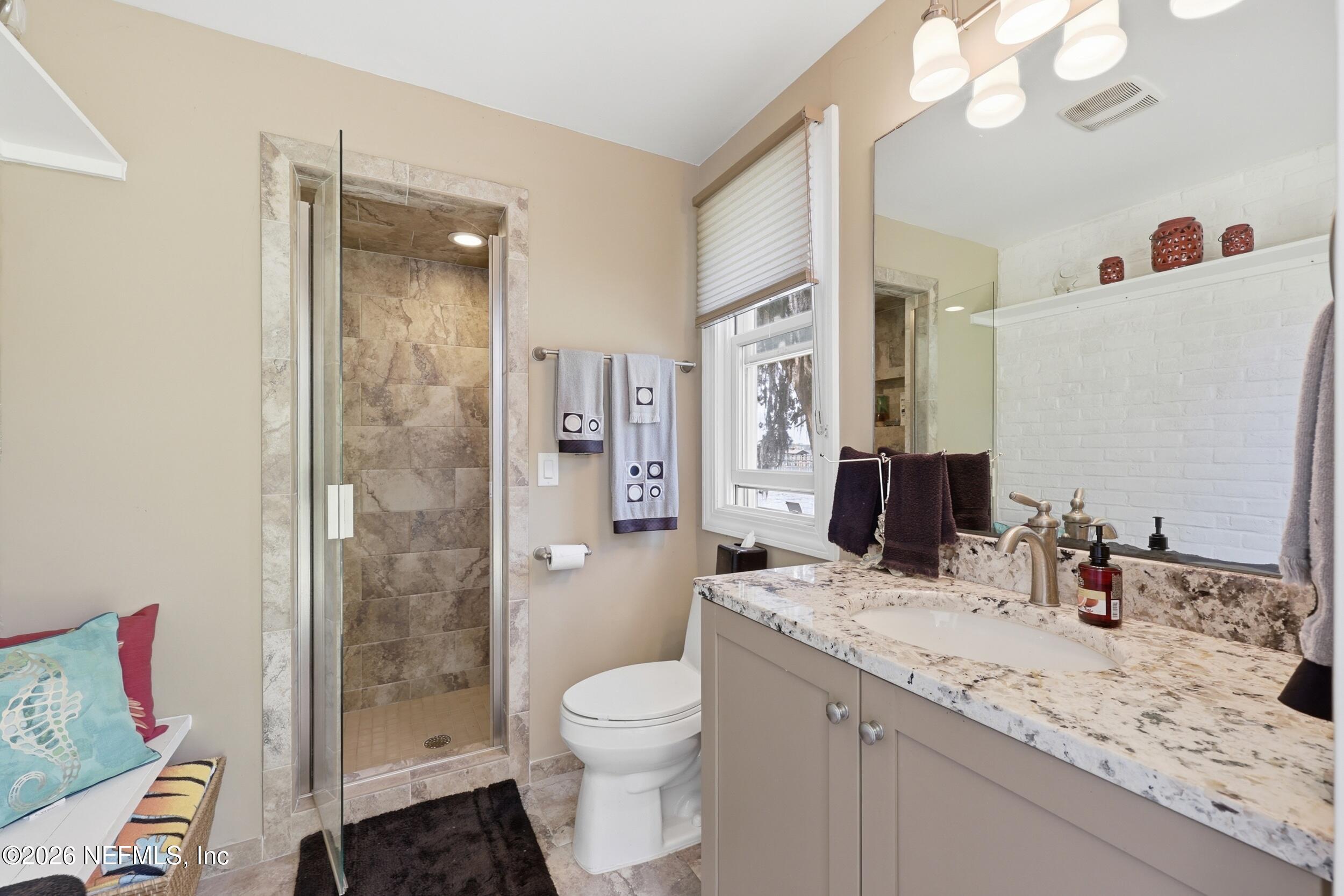 13200 Mandarin Road Jacksonville, FL 32223 - Photo 97 of 173 a bathroom with a granite countertop sink mirror vanity and toilet