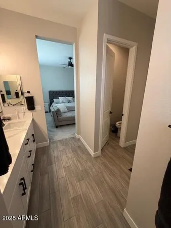 a bedroom with bed and a chandelier