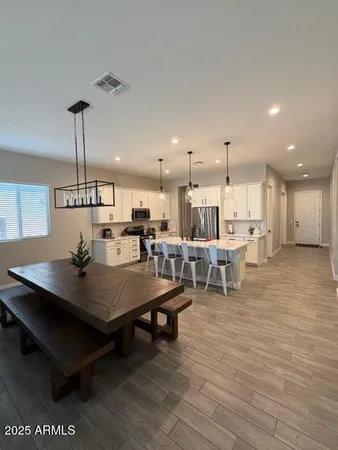 a view of a dining room with furniture and wooden floor