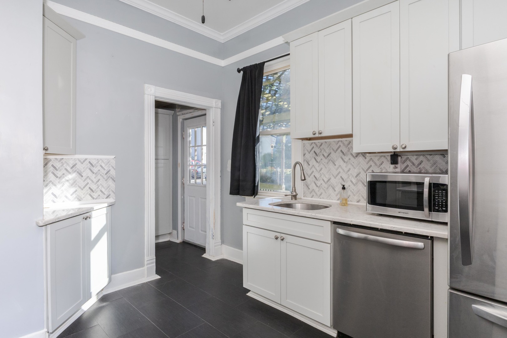 904 South Madison Street Bloomington, IL 61701 - Photo 11 of 46 a kitchen with stainless steel appliances granite countertop a stove and a refrigerator