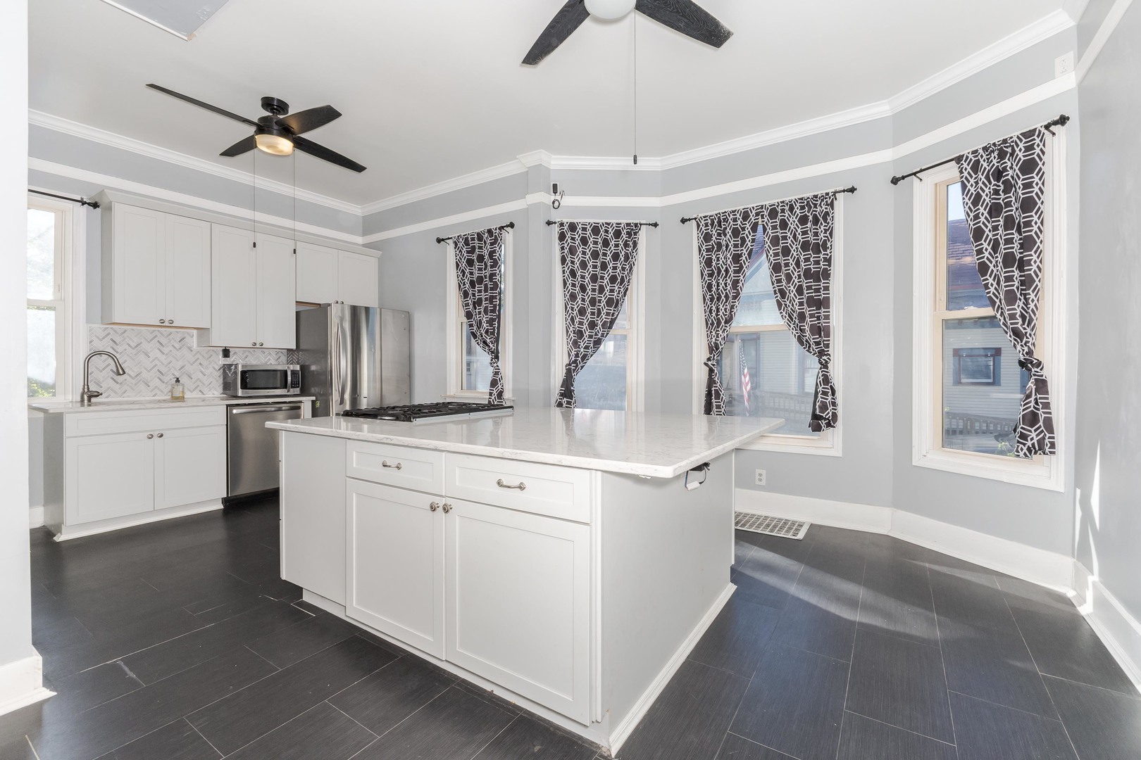 904 South Madison Street Bloomington, IL 61701 - Photo 12 of 46 a kitchen with white cabinets and white appliances