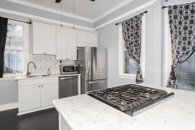 a kitchen with a stove a sink and a refrigerator