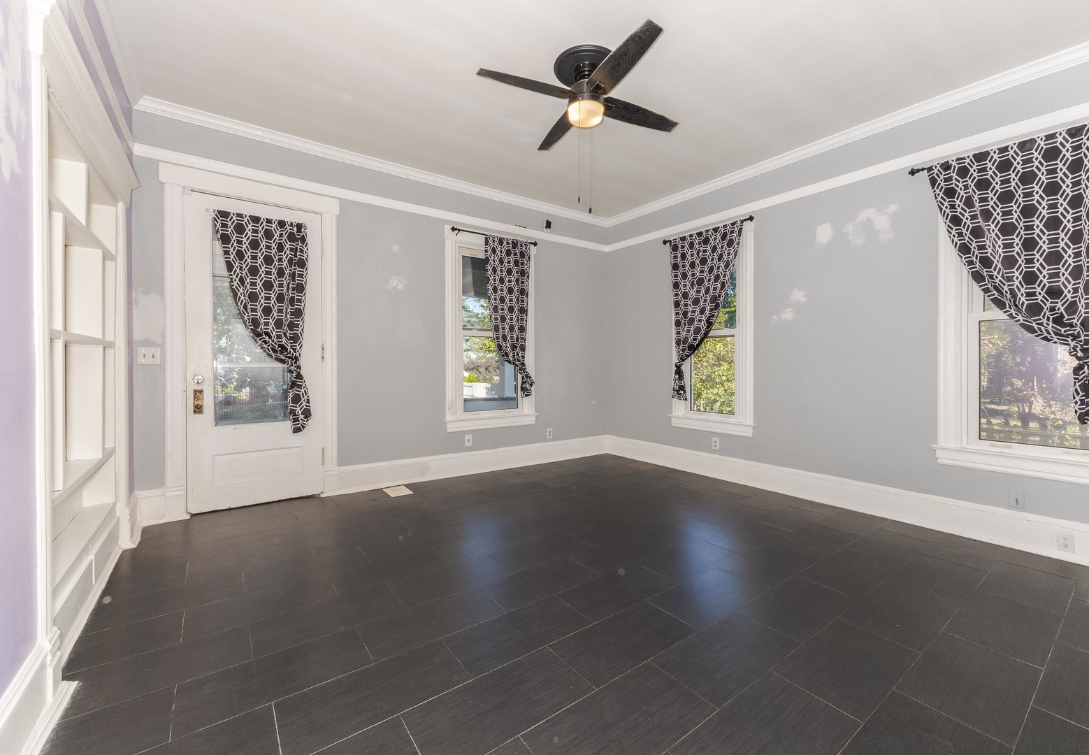 904 South Madison Street Bloomington, IL 61701 - Photo 14 of 46 a view of an empty room with a window and wooden floor