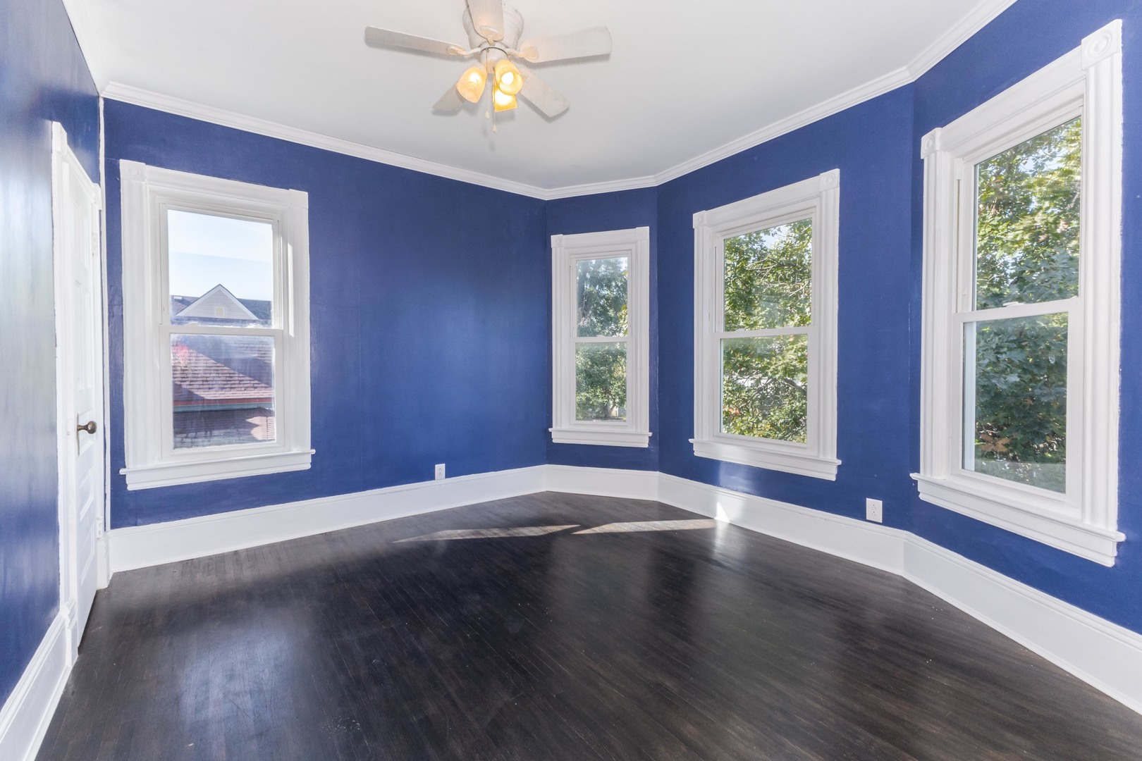904 South Madison Street Bloomington, IL 61701 - Photo 18 of 46 a view of an empty room with wooden floor and a window