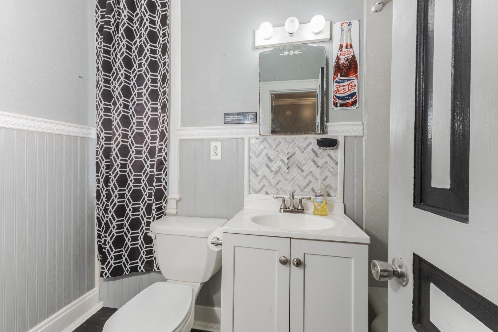 904 South Madison Street Bloomington, IL 61701 - Photo 24 of 46 a bathroom with a toilet sink and mirror