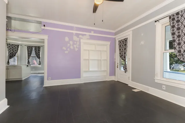 a view of a livingroom with wooden floor and a window