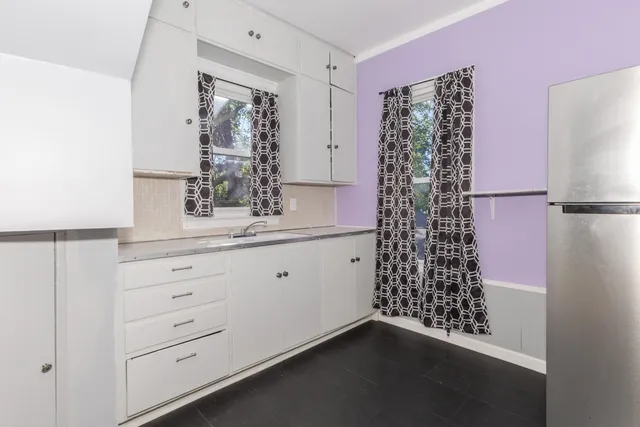 a bathroom with a double vanity sink and shower curtain