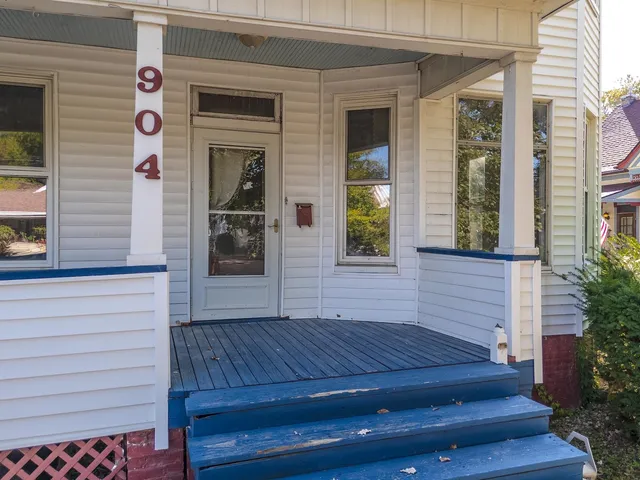 a view of a house with a door and wooden floor