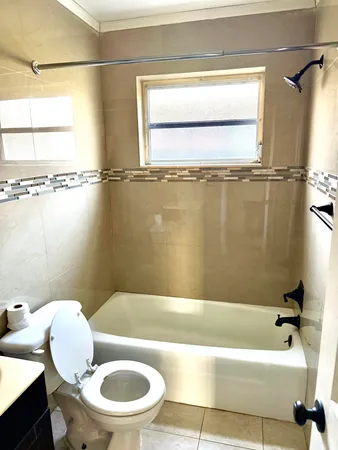 a bathroom with a toilet and a bathtub