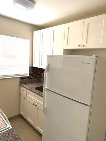 a white refrigerator freezer sitting inside of a kitchen